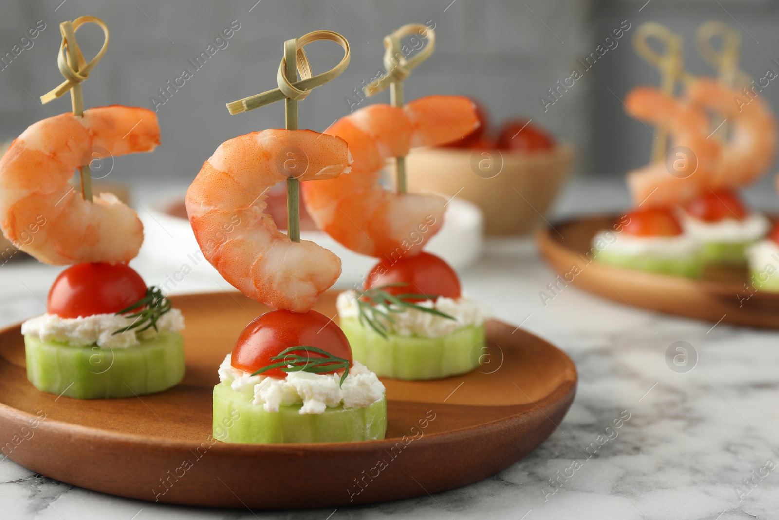 Photo of Tasty canapes with shrimps, vegetables and cream cheese on white marble table, closeup