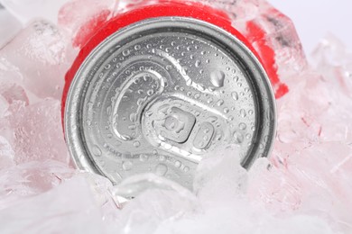 Photo of Energy drink in wet can and ice cubes, closeup