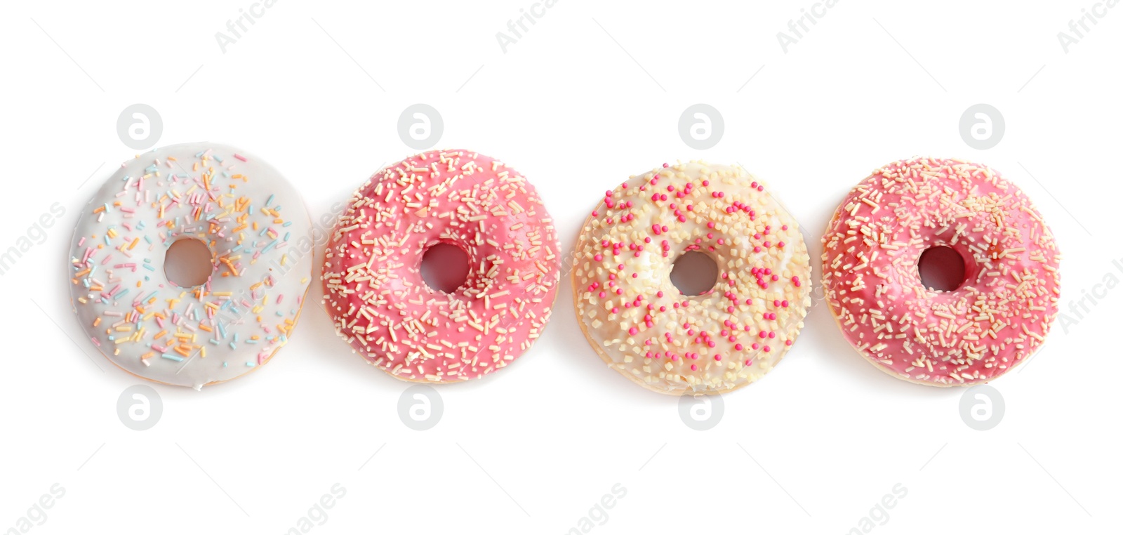 Photo of Delicious glazed doughnuts with sprinkles on light background, top view