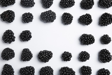 Flat lay composition with ripe blackberries on white background