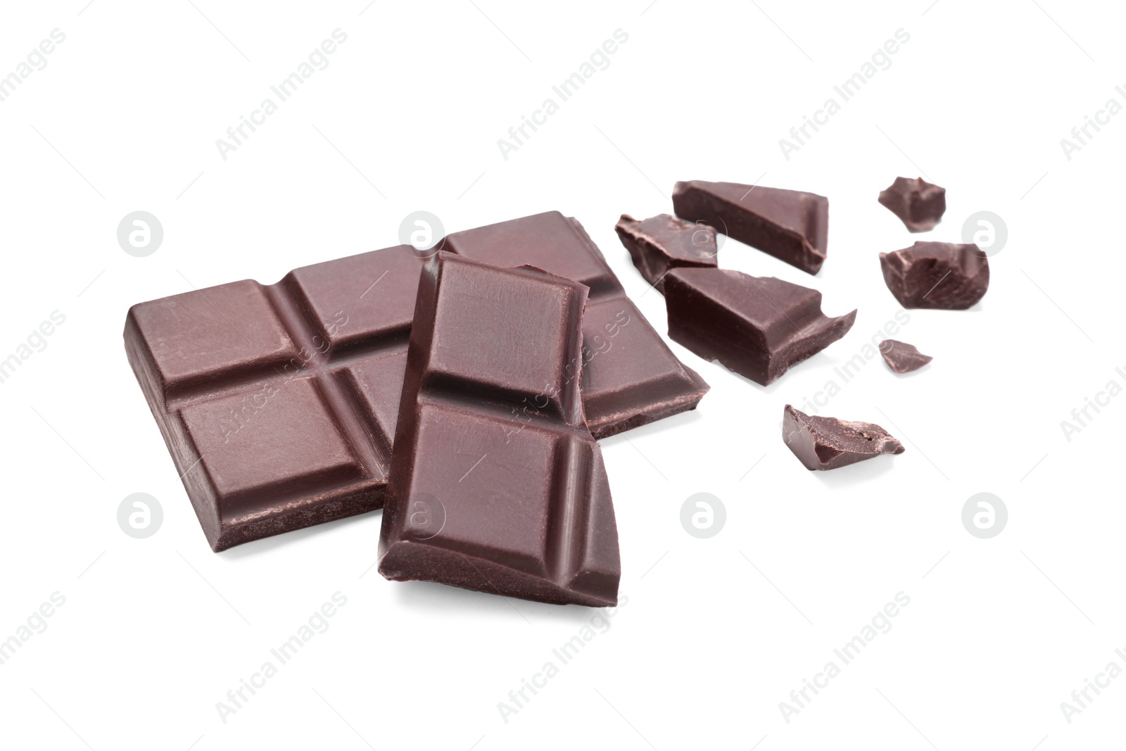 Photo of Pieces of delicious dark chocolate bar on white background