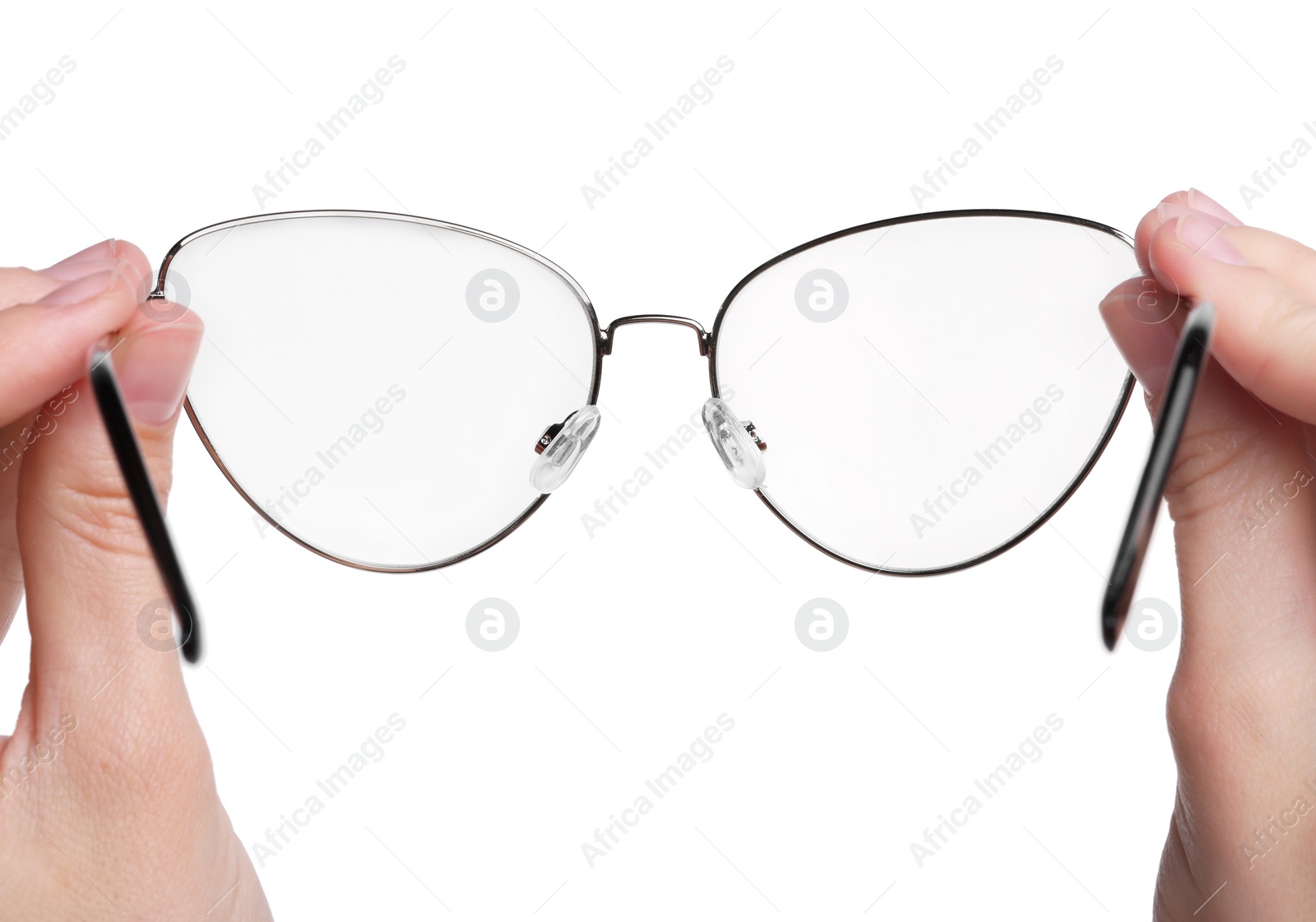 Photo of Woman holding stylish glasses with metal frame on white background, closeup