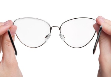 Photo of Woman holding stylish glasses with metal frame on white background, closeup