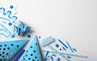 Photo of Flat lay composition with birthday party items on light background