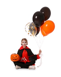 Cute little girl with pumpkin and balloons wearing Halloween costume on white background