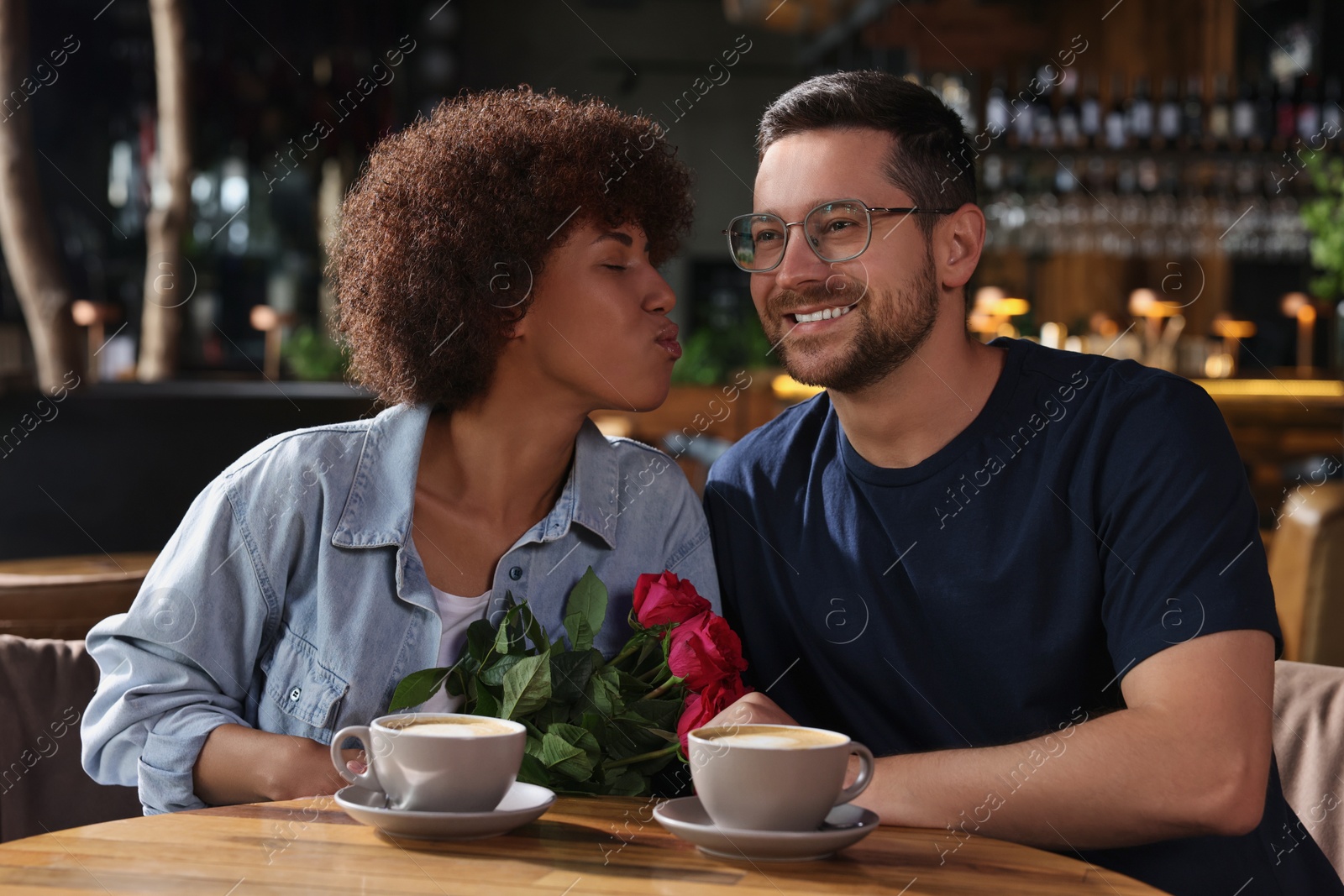 Photo of International dating. Lovely couple spending time together in cafe