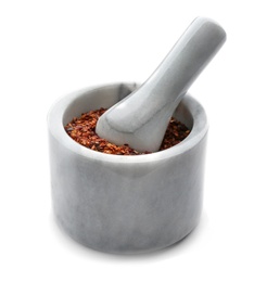 Ceramic mortar with chili pepper flakes on white background