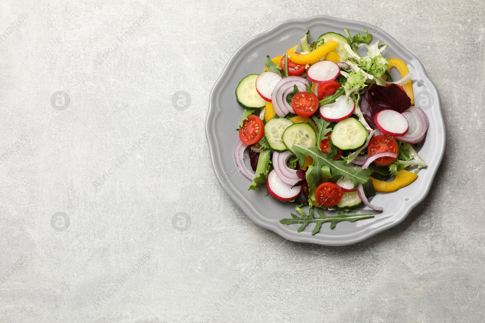 Photo of Balanced diet and vegetarian foods. Plate with different delicious products on grey table, top view. Space for text