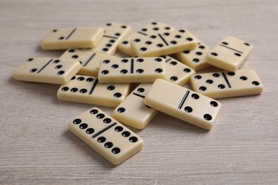 Pile of domino tiles on wooden table