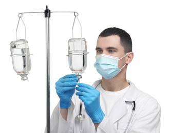 Doctor setting up IV drip on white background
