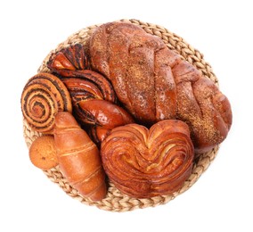 Wicker mat with different pastries isolated on white, top view