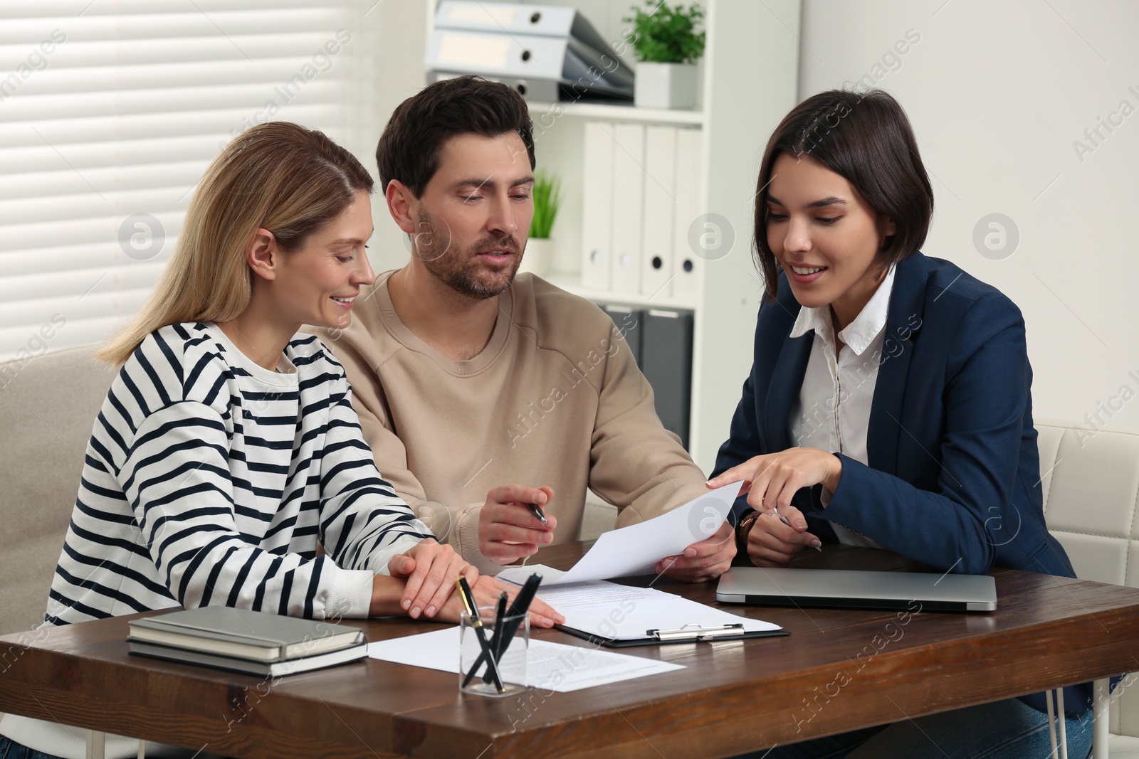 Photo of Professional notary working with couple in office