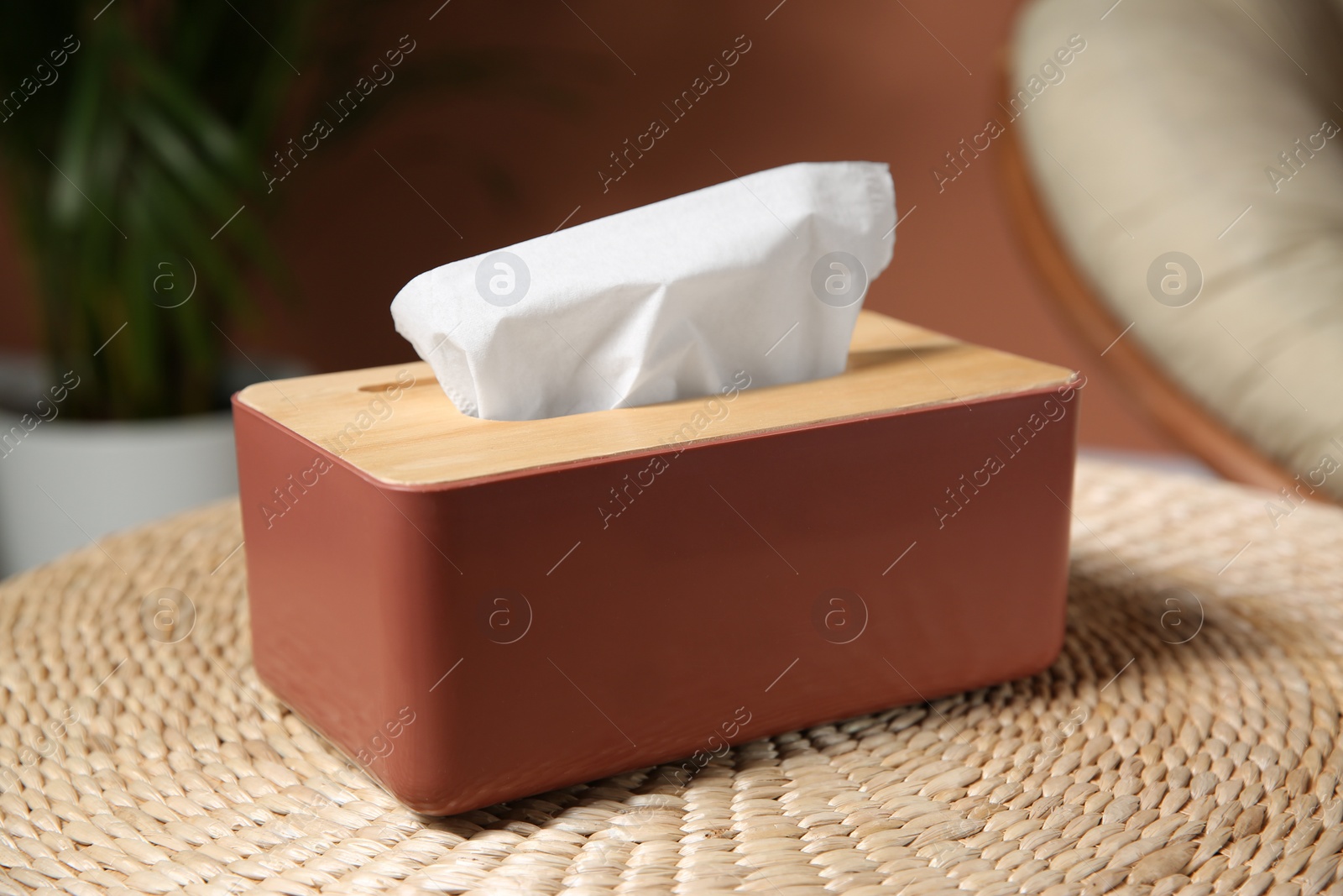 Photo of Box with paper tissues on table in room, closeup