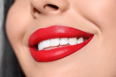 Photo of Young woman wearing beautiful red lipstick, closeup