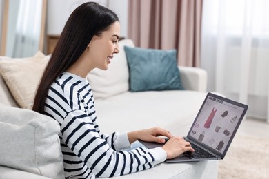Photo of Beautiful young woman with laptop shopping online at home