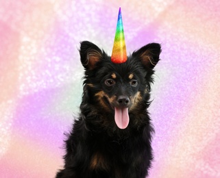 Image of Cute dog with rainbow unicorn horn on blurred sparkling background