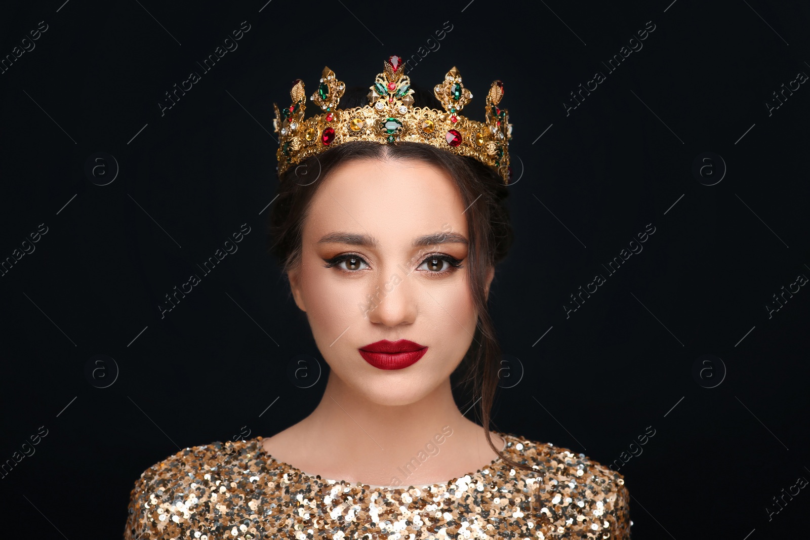 Photo of Beautiful young woman wearing luxurious crown on black background