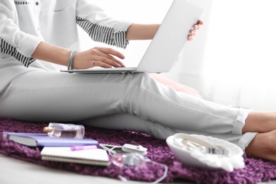 Photo of Female blogger with laptop indoors