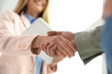 Business partners shaking hands after meeting, closeup