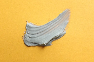 Photo of Sample of face mask on orange background, top view