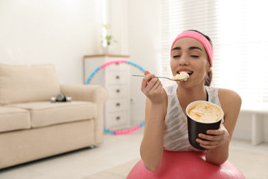 Photo of Lazy young woman eating ice cream at home. Space for text
