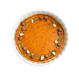 Photo of Delicious pumpkin pie with seeds and hazelnuts isolated on white, top view