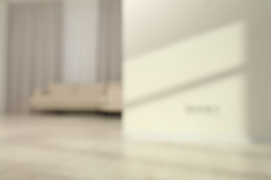 Photo of Blurred view of room with sofa and shadows on wall