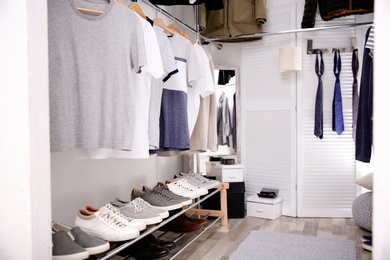 Modern dressing room with different stylish clothes and accessories