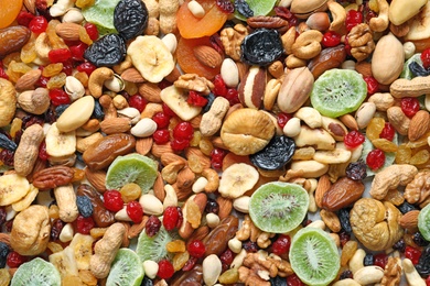 Different dried fruits and nuts as background, closeup