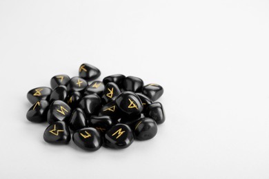 Photo of Pile of black rune stones on white background