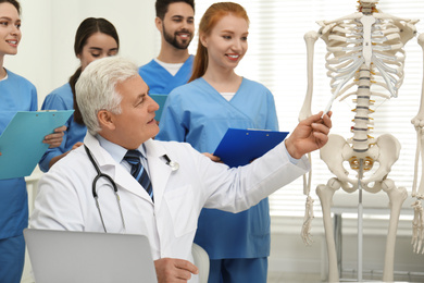 Photo of Professional orthopedist teaching medical students in clinic