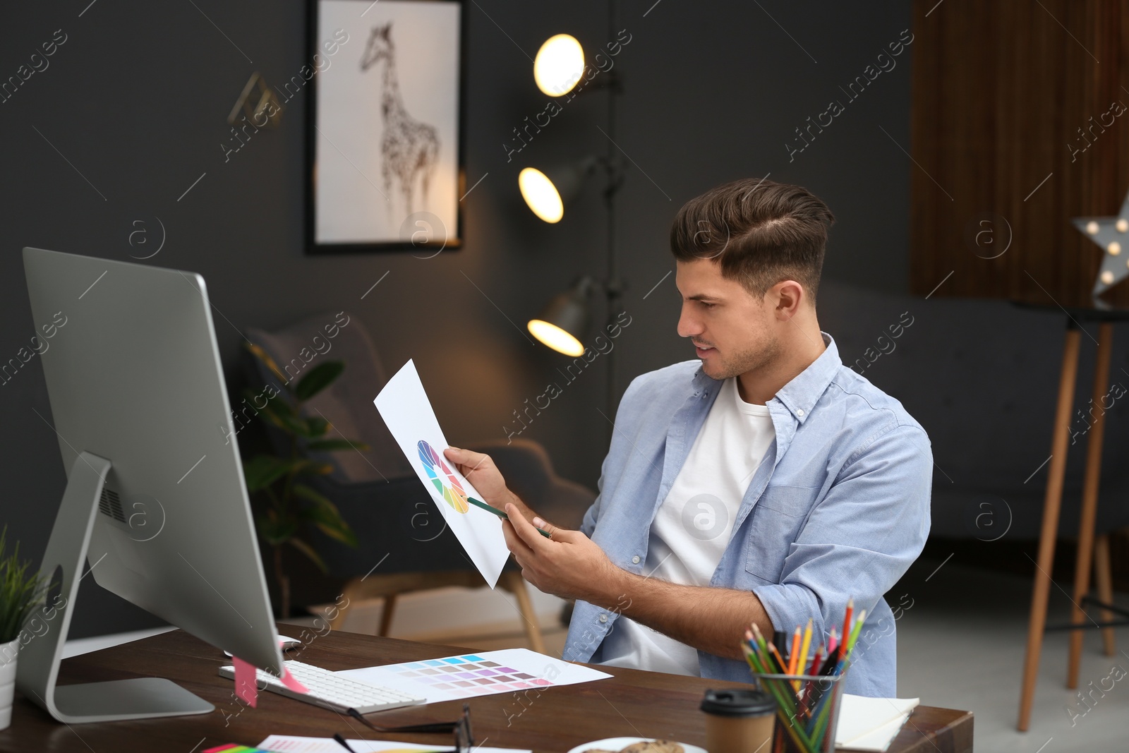 Photo of Male designer working at desk in office