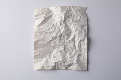 Photo of Crumpled sheet of paper on white background, top view
