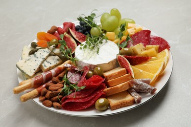 Photo of Set of different delicious appetizers served on light grey table
