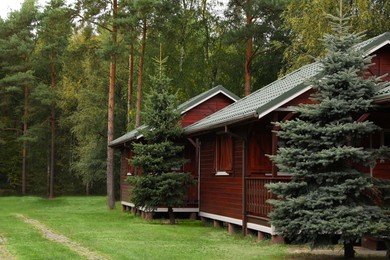 Photo of Beautiful wooden beach houses and green trees outdoors