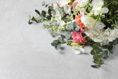 Photo of Bouquet of beautiful flowers on light gray table. Space for text