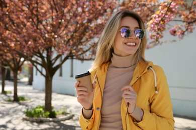 Photo of Tourist with cup of coffee on city street