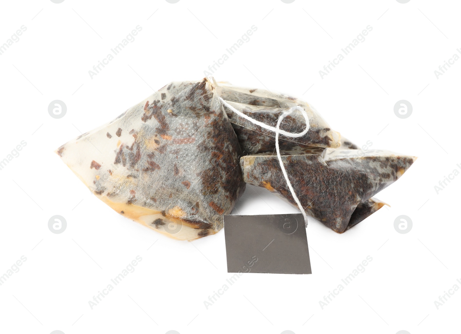 Photo of Used pyramid tea bags on white background