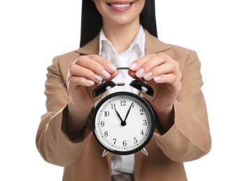 Photo of Businesswoman holding alarm clock on white background, closeup. Time management