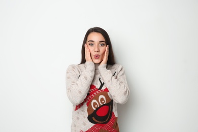 Photo of Young woman in Christmas sweater on white background