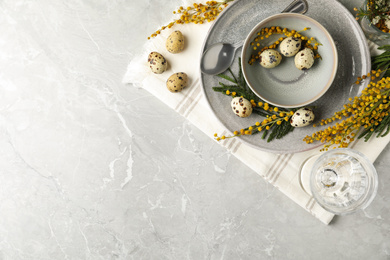 Photo of Festive Easter table setting with beautiful mimosa flowers, flat lay. Space for text