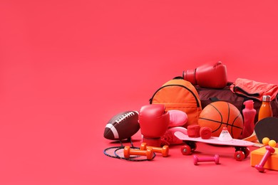 Photo of Many different sports equipment on red background, space for text