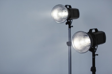 Photo of Studio lighting against gray background. Professional photo equipment