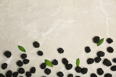 Photo of Flat lay composition with fresh blackberry and space for text on gray background