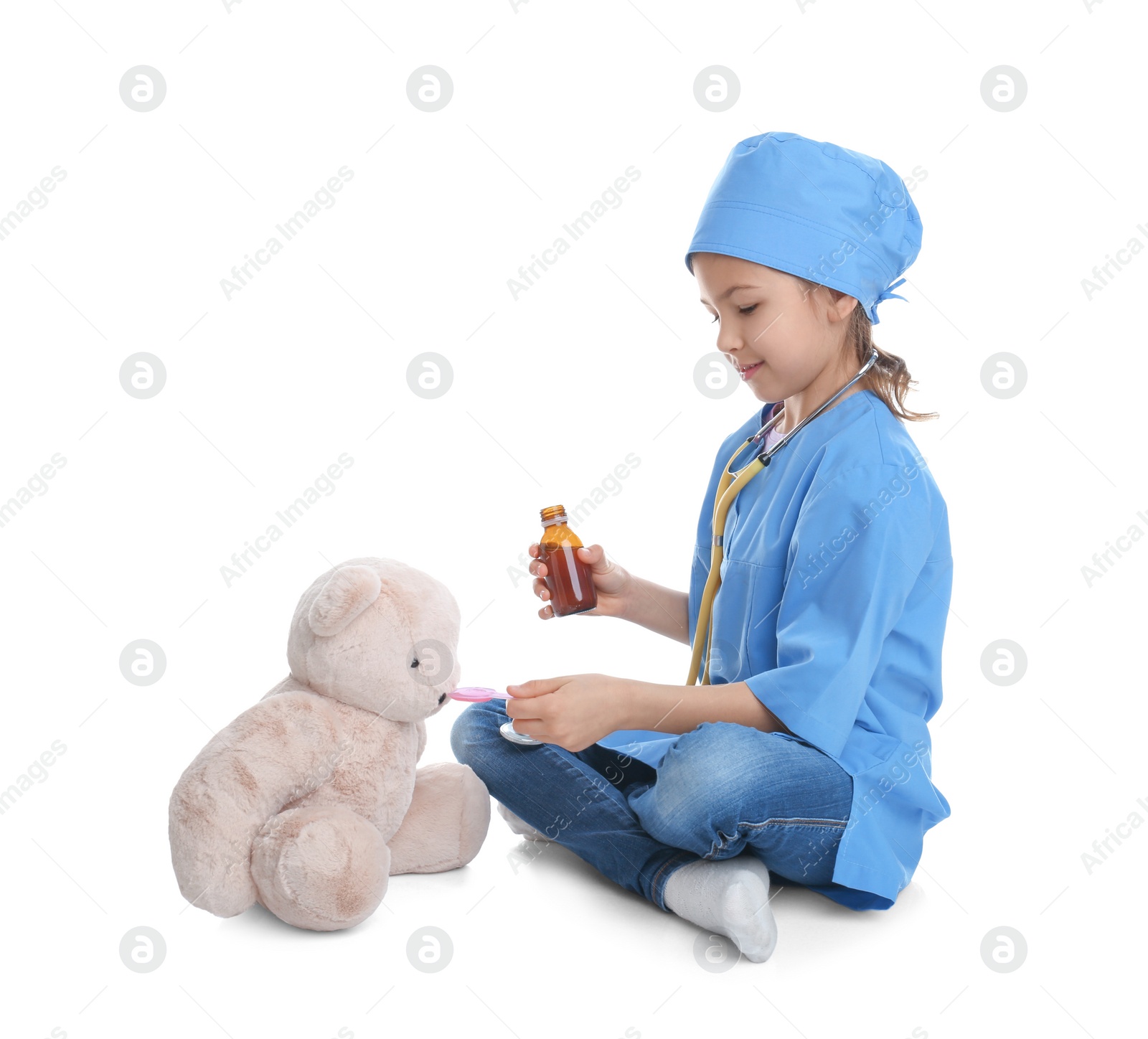Photo of Cute child playing doctor with stuffed toy on white background