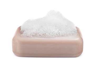 Photo of Soap bar with fluffy foam on white background