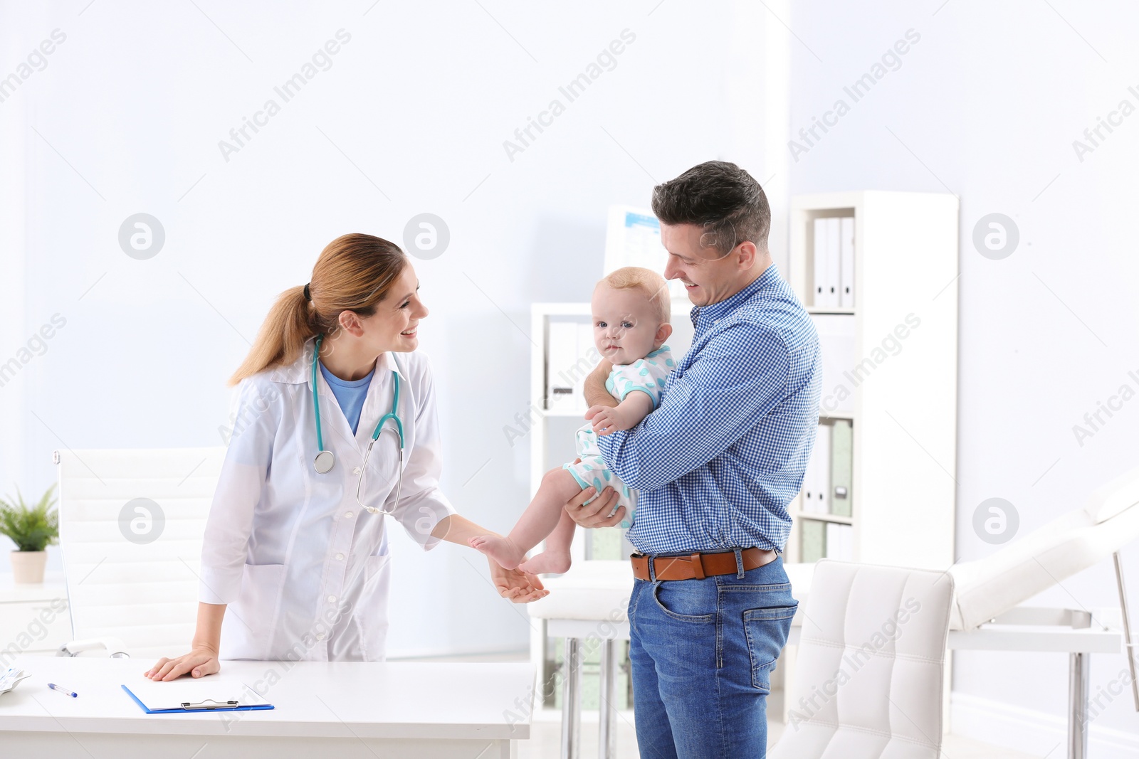 Photo of Man with his baby visiting children's doctor in hospital