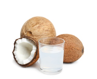 Photo of Glass of coconut milk and nuts on white background