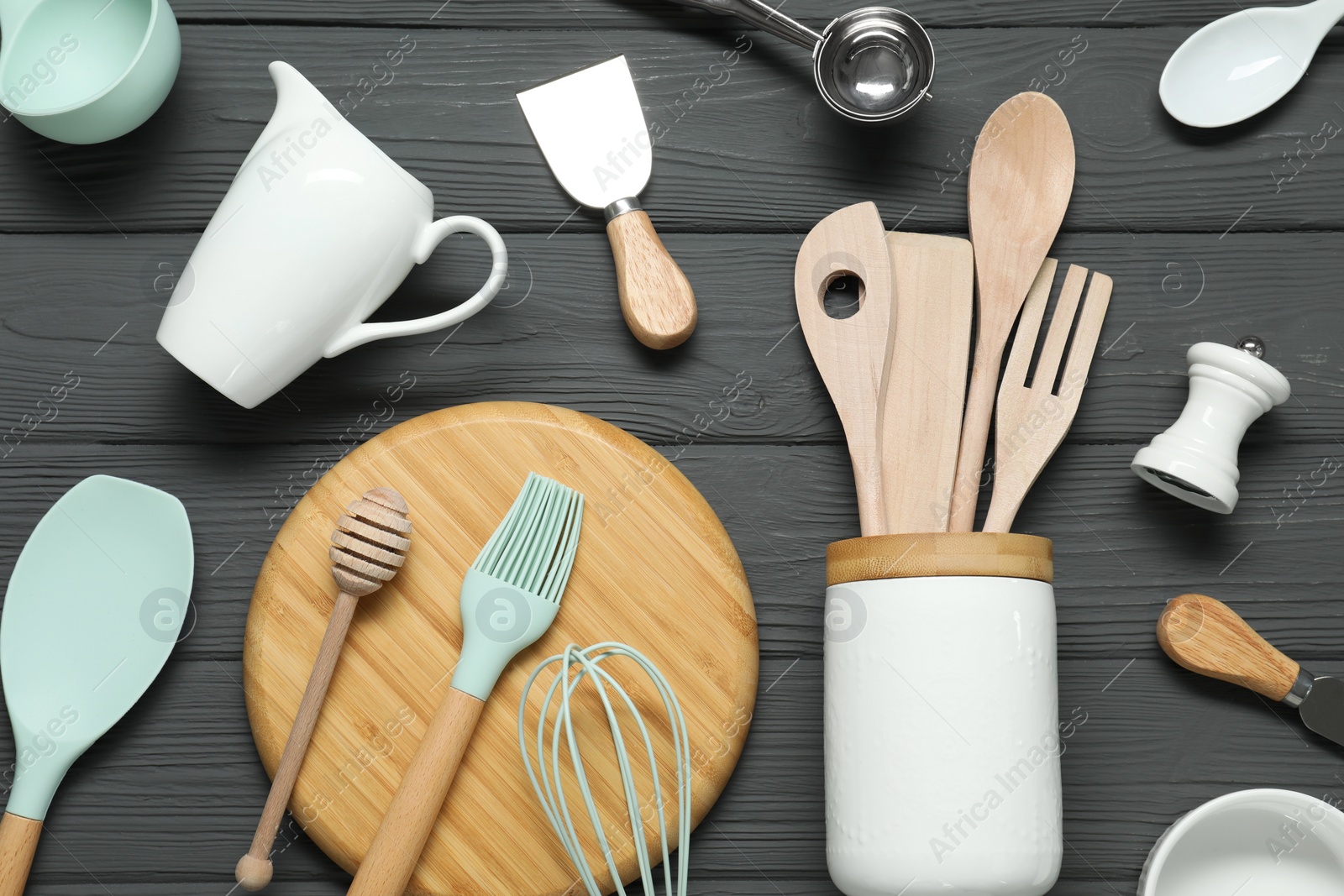 Set of different kitchen utensils on grey wooden table, flat lay Photo of Set of different kitchen utensils on grey wooden table, flat lay