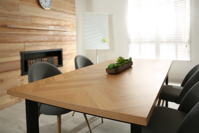 Photo of Modern meeting room interior with large table and chairs